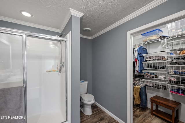 648 Old Douglas Dam Rd, Sevierville, TN 37876 - full bath featuring toilet, wood finished floors, crown molding, a shower stall, and a spacious closet