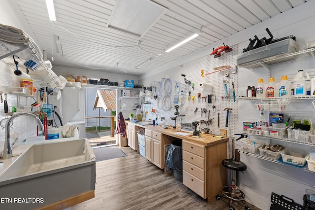 648 Old Douglas Dam Rd, Sevierville, TN 37876 - interior space featuring a sink, a workshop area, and wood finished floors