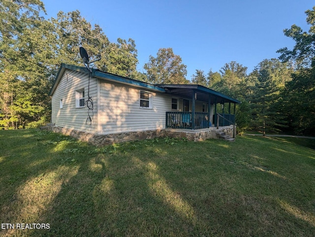 430 Buell Ln, Speedwell, TN 37870 - back of house featuring a yard and covered porch