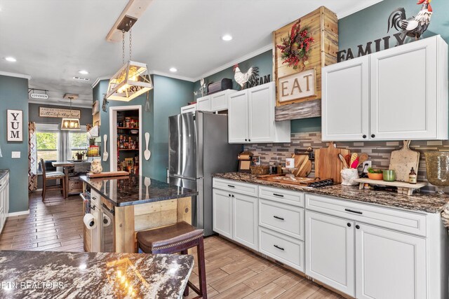 1842 Chapel Rd, Sevierville, TN 37876 - kitchen featuring crown molding, freestanding refrigerator, and backsplash