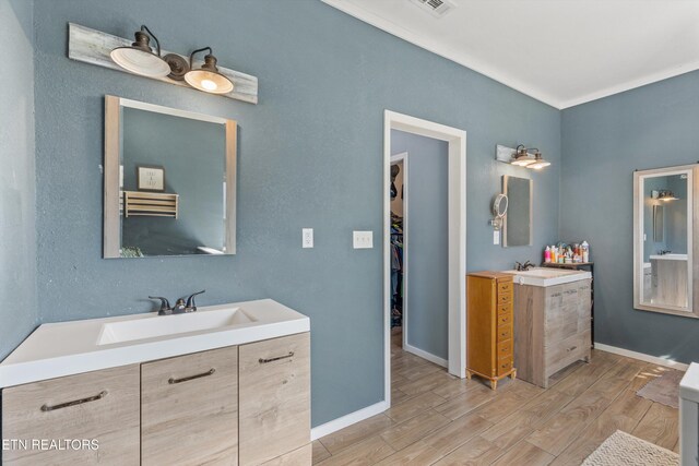 1842 Chapel Rd, Sevierville, TN 37876 - full bathroom featuring two vanities, baseboards, a sink, and wood finished floors