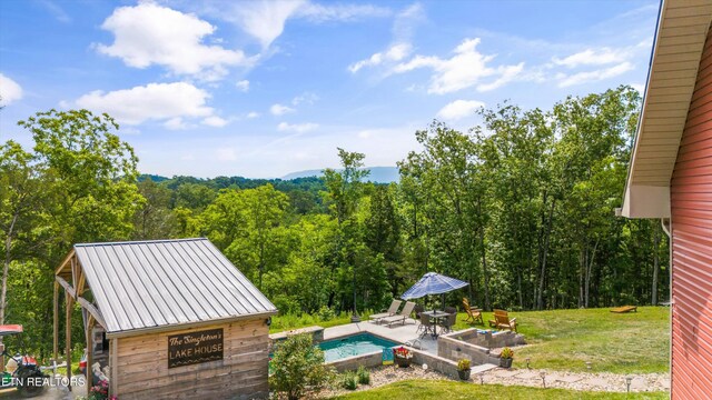 1842 Chapel Rd, Sevierville, TN 37876 - outdoor pool featuring a yard, a patio area, and a wooded view