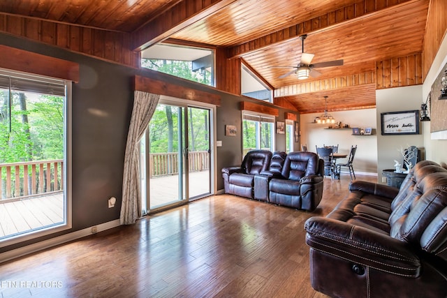 living room with baseboards, vaulted ceiling with beams, ceiling fan with notable chandelier, and wood ceiling