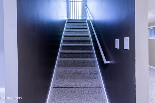 stairway with carpet and baseboards