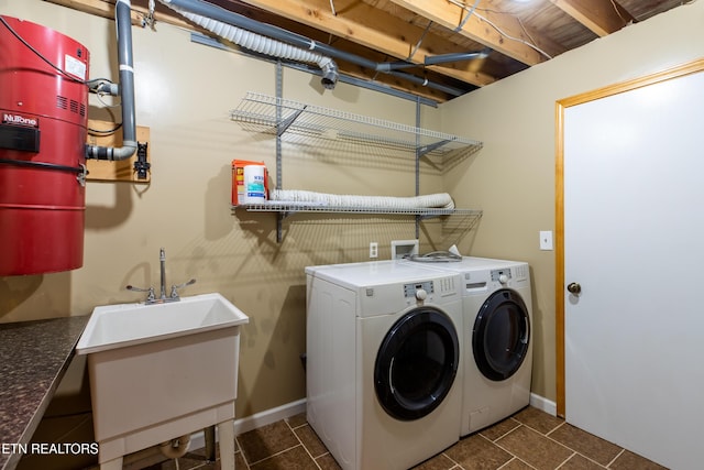 laundry area featuring a sink, laundry area, and independent washer and dryer