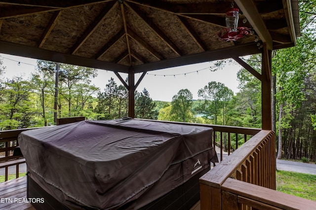 wooden terrace featuring a gazebo