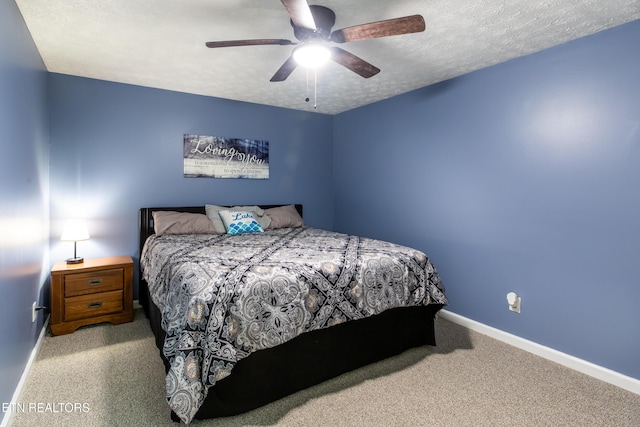 bedroom with carpet, ceiling fan, a textured ceiling, and baseboards