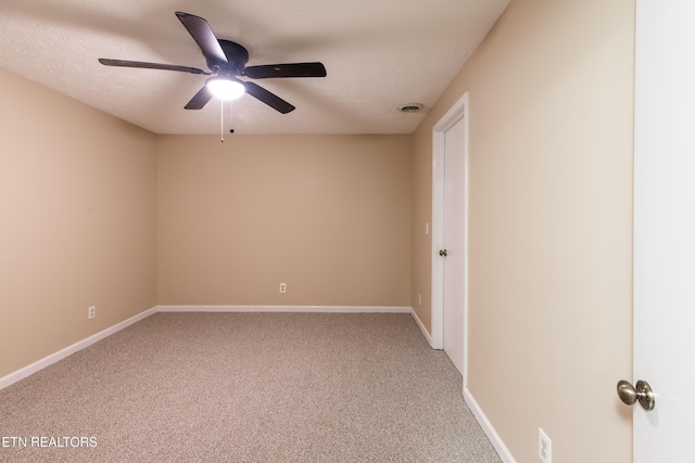 empty room with ceiling fan, carpet, and baseboards