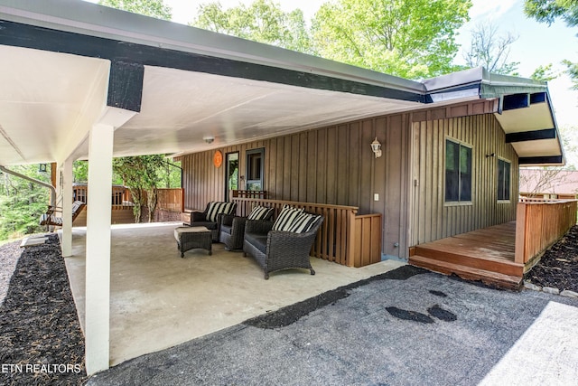 view of patio / terrace featuring a deck and an attached carport
