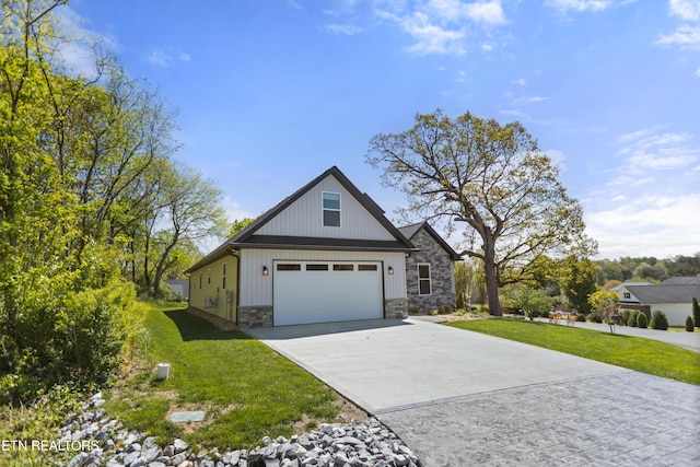 view of front of property with a garage, driveway, stone siding, and a front yard