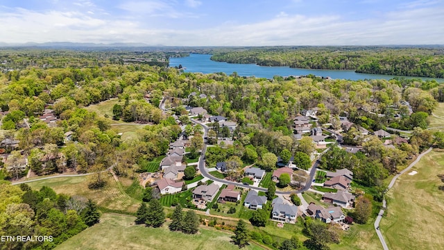 birds eye view of property featuring a residential view, a forest view, and a water view