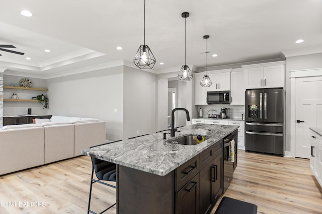 kitchen featuring black refrigerator with ice dispenser, white cabinetry, ornamental molding, and a sink