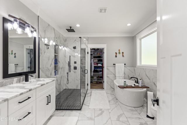 bathroom featuring a marble finish shower, a spacious closet, vanity, marble finish floor, and a freestanding bath