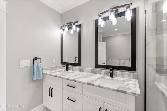 bathroom with a shower with shower door, double vanity, and a sink