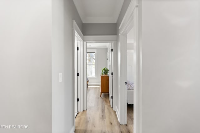 corridor featuring baseboards and light wood-style floors