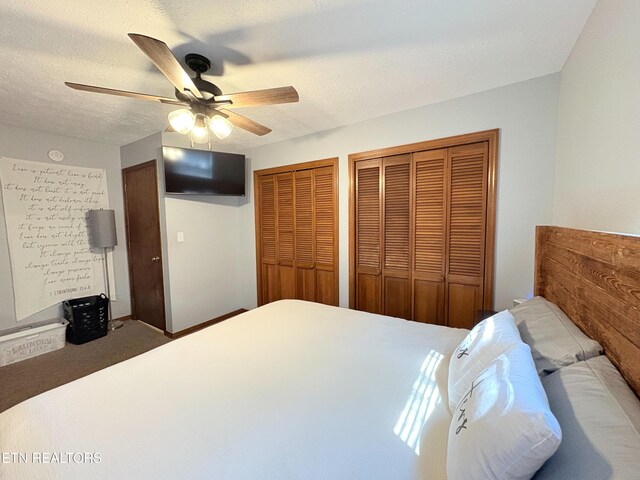 bedroom featuring a textured ceiling, multiple closets, and ceiling fan