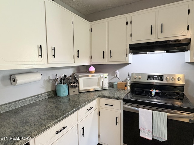 kitchen featuring dark countertops, white cabinetry, white microwave, electric range, and under cabinet range hood