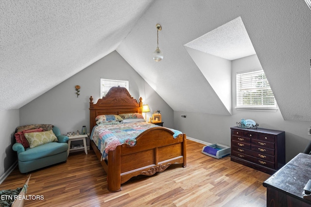 12903 Georgetown Village Ln, Georgetown, TN 37336 - bedroom with a textured ceiling, wood finished floors, vaulted ceiling, and baseboards