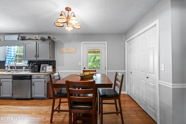 12903 Georgetown Village Ln, Georgetown, TN 37336 - dining space with a textured ceiling, light wood finished floors, healthy amount of natural light, and a chandelier