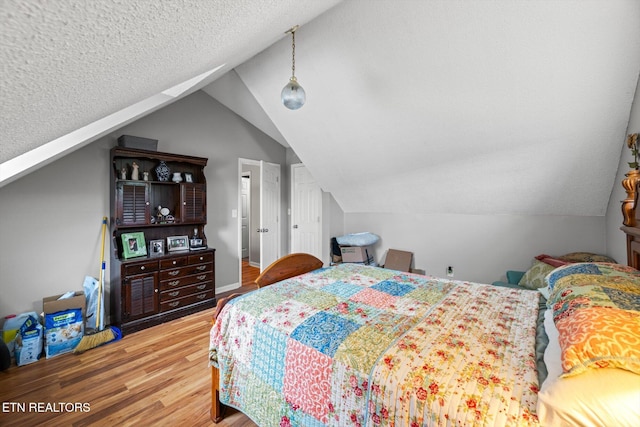 12903 Georgetown Village Ln, Georgetown, TN 37336 - bedroom with wood finished floors, vaulted ceiling, and a textured ceiling