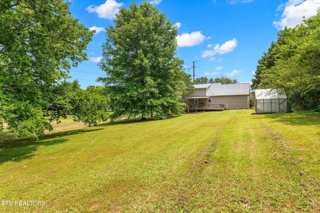 12903 Georgetown Village Ln, Georgetown, TN 37336 - view of green lawn featuring an exterior structure, an outdoor structure, and a deck