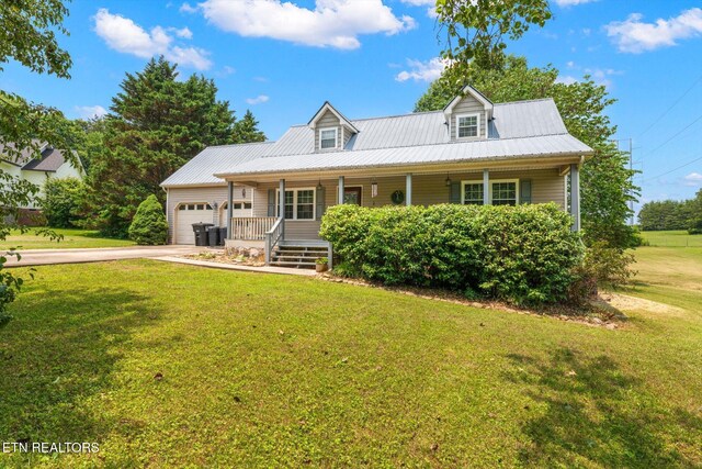 12903 Georgetown Village Ln, Georgetown, TN 37336 - cape cod home with a porch, an attached garage, driveway, a front lawn, and metal roof