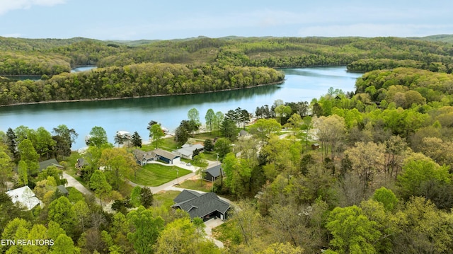 aerial view featuring a view of trees and a water view