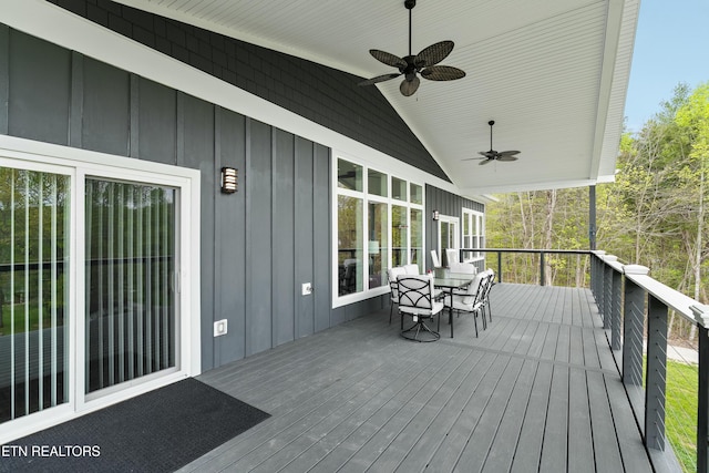 deck featuring outdoor dining space and ceiling fan