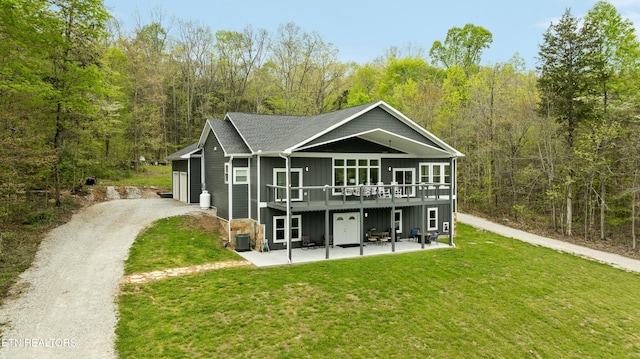 rear view of property with central AC unit, a view of trees, a yard, and a deck