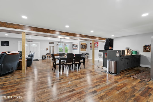 dining room with baseboards, bar, recessed lighting, and dark wood finished floors
