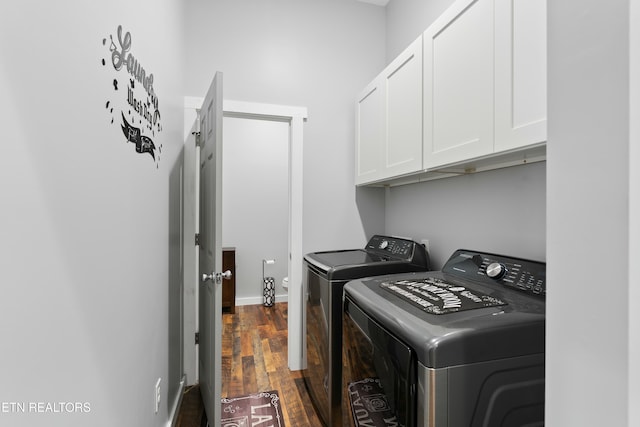 washroom featuring baseboards, dark wood-style floors, independent washer and dryer, and cabinet space