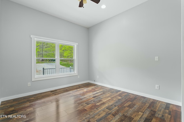 spare room featuring hardwood / wood-style flooring, ceiling fan, baseboards, and visible vents