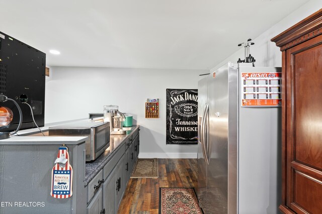 interior space with recessed lighting, freestanding refrigerator, baseboards, and dark wood-style flooring