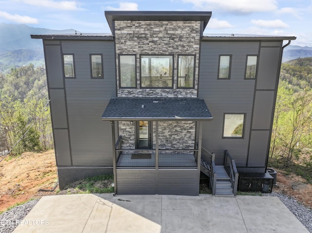 896 Chalet Village Blvd, Gatlinburg, TN 37738 - rear view of property featuring a mountain view, stone siding, and a patio