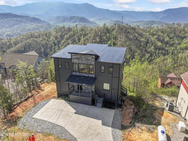 896 Chalet Village Blvd, Gatlinburg, TN 37738 - modern home with a view of trees, a mountain view, central air condition unit, and stone siding