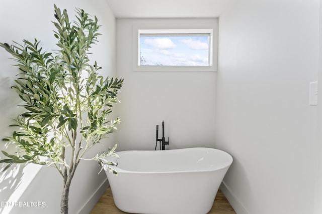 896 Chalet Village Blvd, Gatlinburg, TN 37738 - full bath with baseboards, a freestanding tub, and wood finished floors