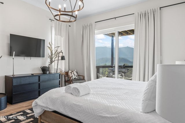 896 Chalet Village Blvd, Gatlinburg, TN 37738 - bedroom featuring a mountain view, access to exterior, a chandelier, and wood finished floors