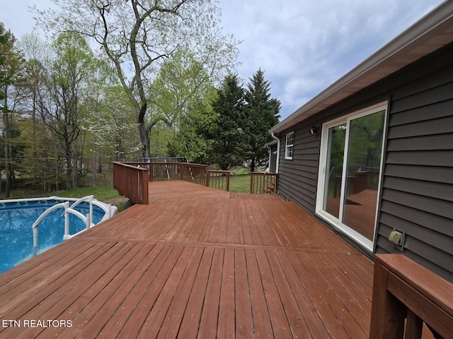 wooden deck featuring an outdoor pool