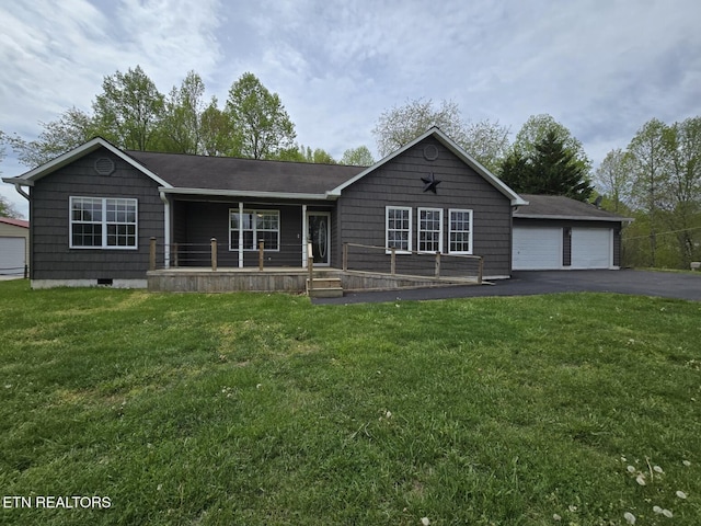 ranch-style home featuring a garage, a porch, and a front lawn