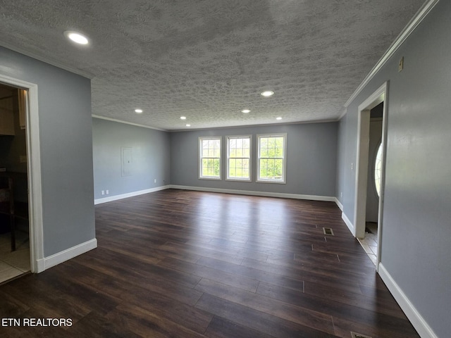 spare room with baseboards, recessed lighting, ornamental molding, and dark wood-style flooring