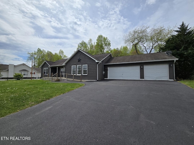 ranch-style house featuring an attached garage, driveway, and a front yard