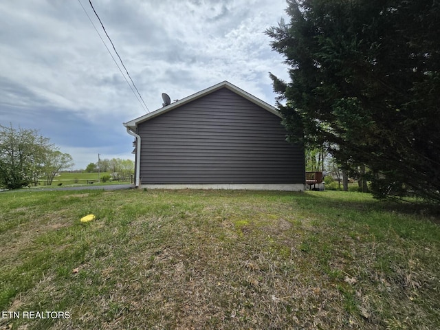 view of property exterior featuring a lawn