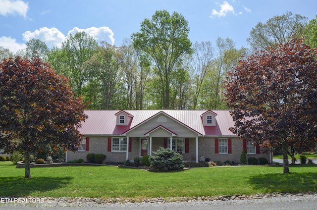 76 Sundrop Ln, Crossville, TN 38571 - view of front of house featuring brick siding, a front lawn, and a metal roof