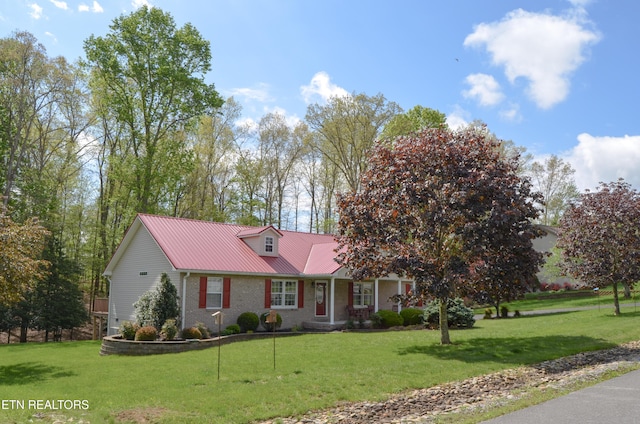76 Sundrop Ln, Crossville, TN 38571 - view of front facade with a metal roof, a front lawn, a porch, and brick siding