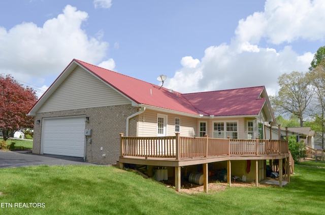 76 Sundrop Ln, Crossville, TN 38571 - rear view of house featuring a deck, asphalt driveway, a metal roof, a yard, and a garage