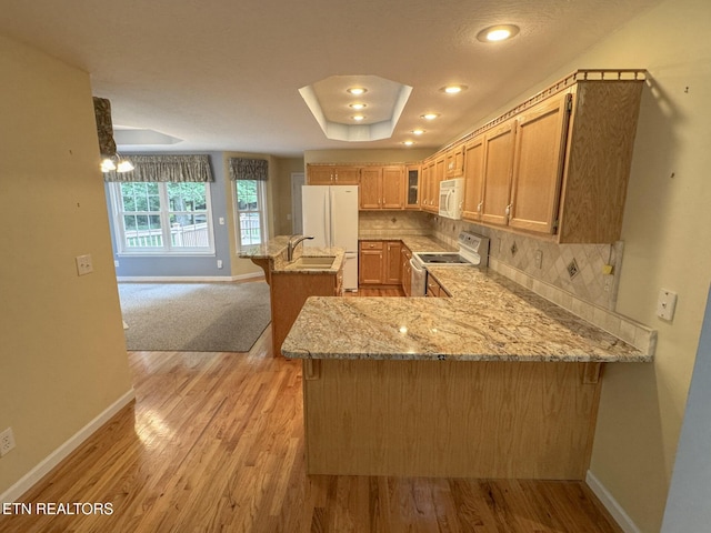 76 Sundrop Ln, Crossville, TN 38571 - kitchen with white appliances, light stone countertops, glass insert cabinets, a peninsula, and light wood finished floors