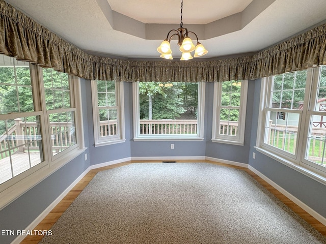 76 Sundrop Ln, Crossville, TN 38571 - unfurnished sunroom featuring wood finished floors, a chandelier, and a raised ceiling