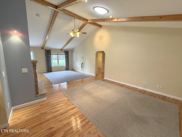 76 Sundrop Ln, Crossville, TN 38571 - unfurnished living room featuring a ceiling fan, light wood finished floors, and arched walkways