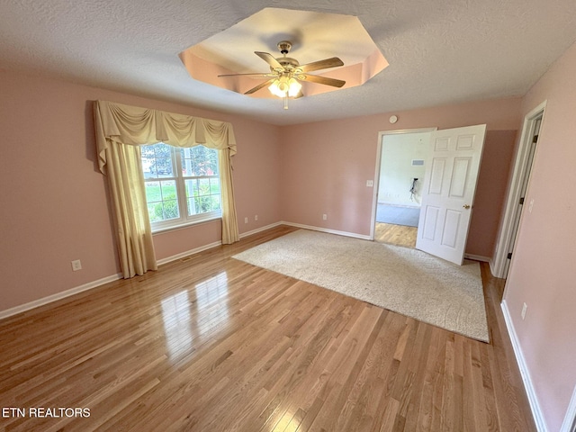 76 Sundrop Ln, Crossville, TN 38571 - empty room with light wood-style flooring, a textured ceiling, and ceiling fan