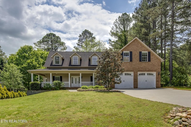100 Coyatee Cir, Loudon, TN 37774 - cape cod-style house with a porch, brick siding, driveway, a garage, and a front yard